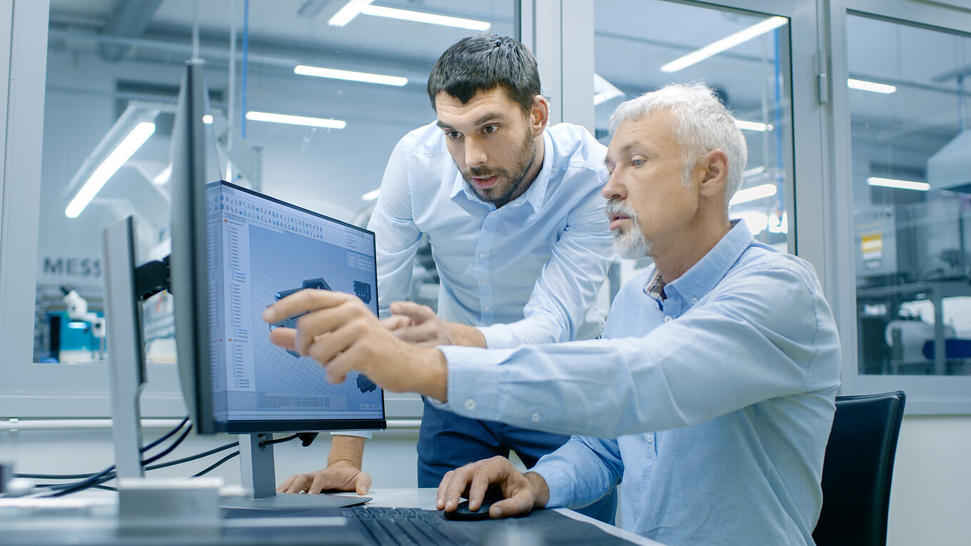 Industrial,Designer,Has,Conversation,With,Senior,Engineer,While,Working,In