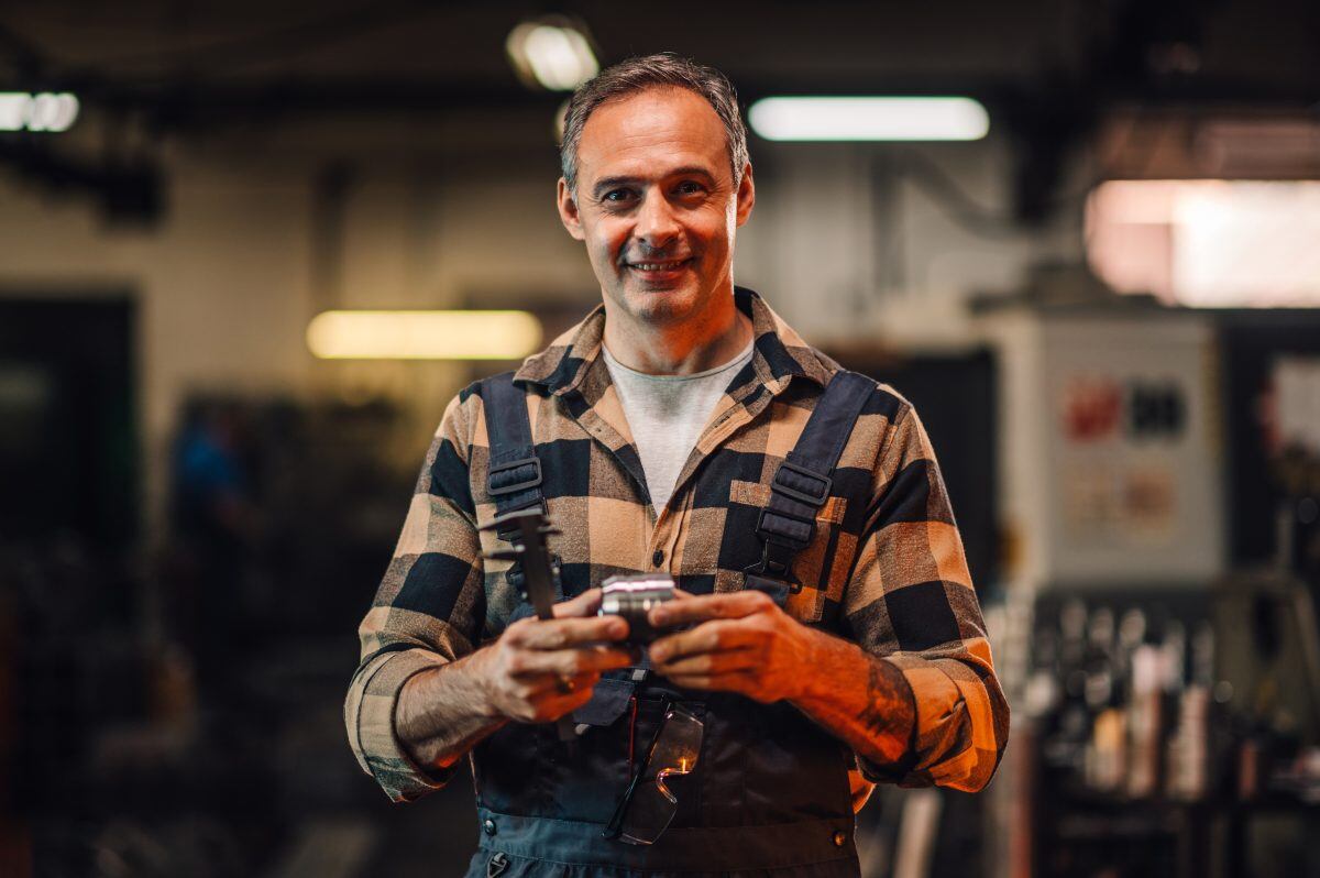 A,Portrait,Of,A,Grey,Haired,Machinist,Showing,A,Metal