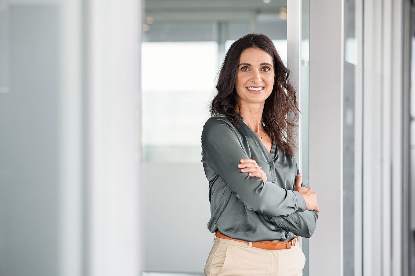 Portrait,Of,Mature,Business,Woman,With,Arms,Crossed,Looking,At