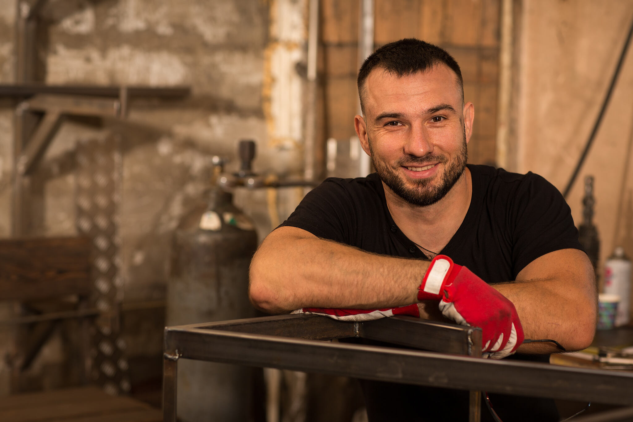 Strong,Young,Bearded,Male,Worker,,Leaning,With,Both,Hands,On